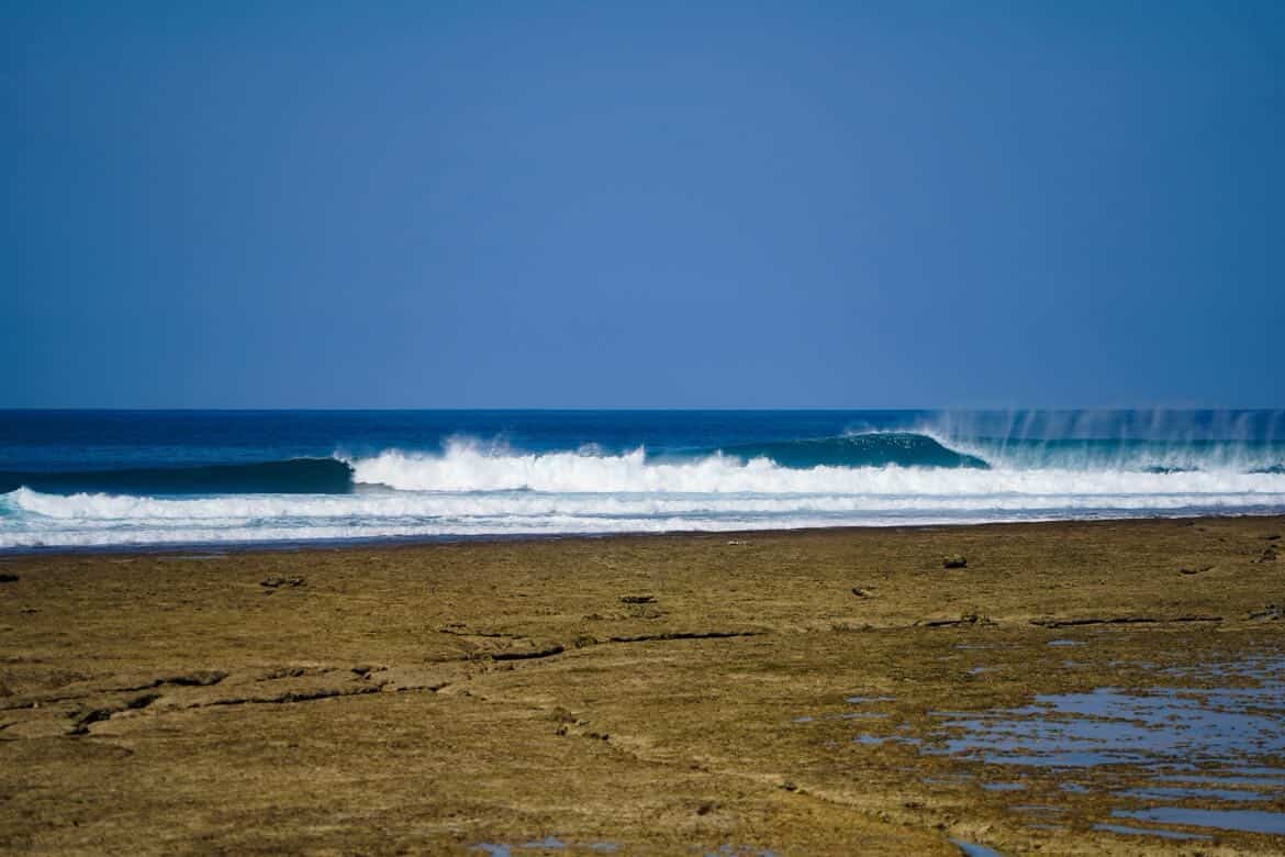 Boa Beach, Rote Island — a perfect wave breaks over the reef flat